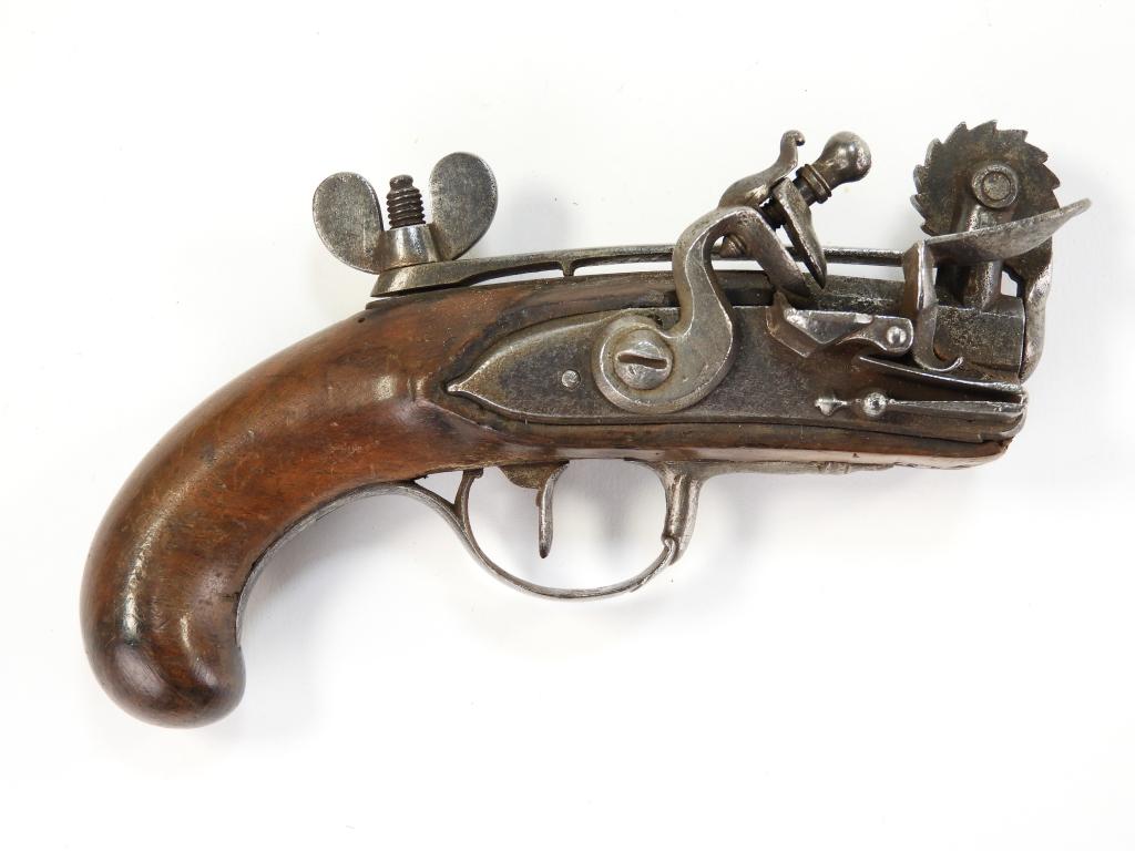 Flintlock Powder Tester: Continental C. mid to late-18th century Walnut stock, steel trigger guard and side plate, flat lock plate with a beveled edge, and a steel measuring wheel with numbers on the left side. Overall lg. 5 