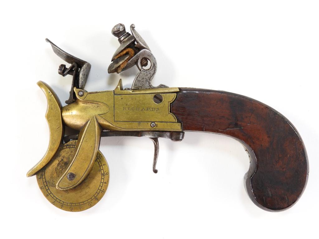 Flintlock Powder Tester: England C. late 18th/early 19th century Walnut grip, brass frame marked on the left side "RICHARD'S," and on the right side "LONDON," with a reinforced cock, and a brass measurement wheel. Overall lg.
