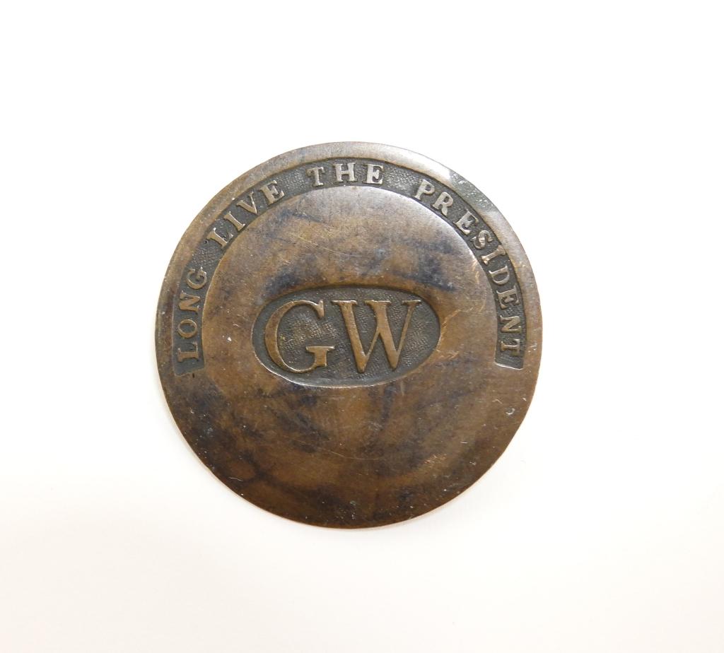 George Washington Inaugural Button: United States C. 1789 Marked on the obverse "LONG LIVE THE PRESIDENT" and "GW" in an oval, plain reverse with a soldered original shank. Dia. 34.1 mm.