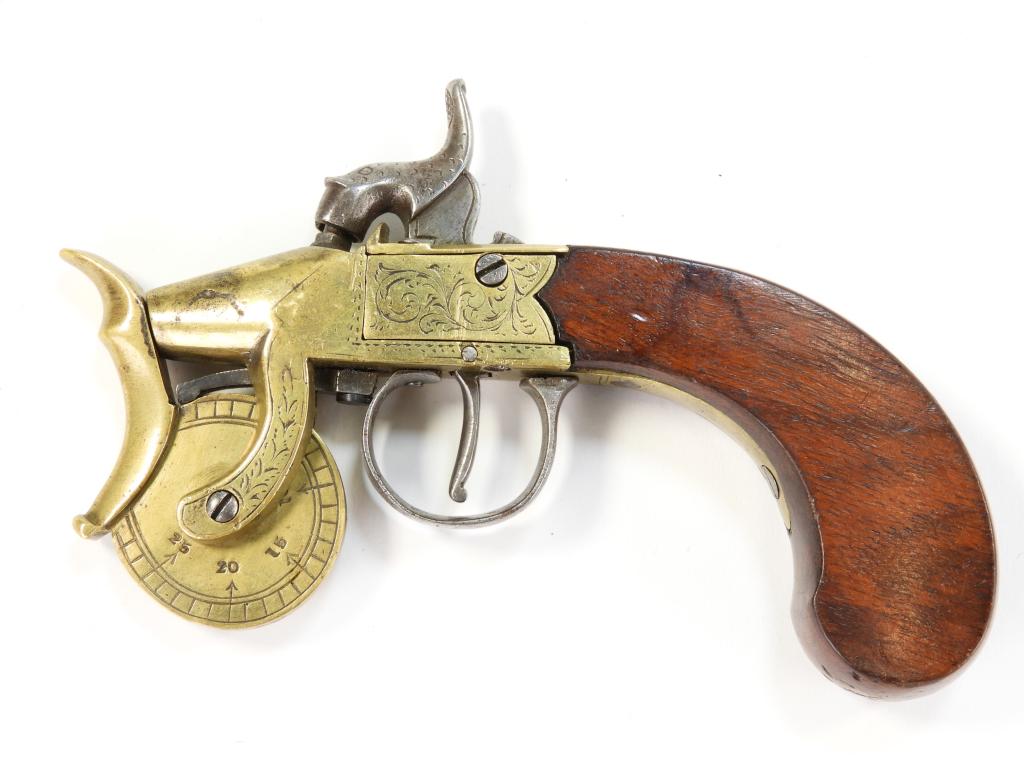 Percussion Powder Tester: England C. 1840s Walnut grip with a small silver escutcheon, brass frame engraved with foliate designs, engraved steel hammer, and a brass measuring wheel with numbers on the left side. Overall lg. 6 