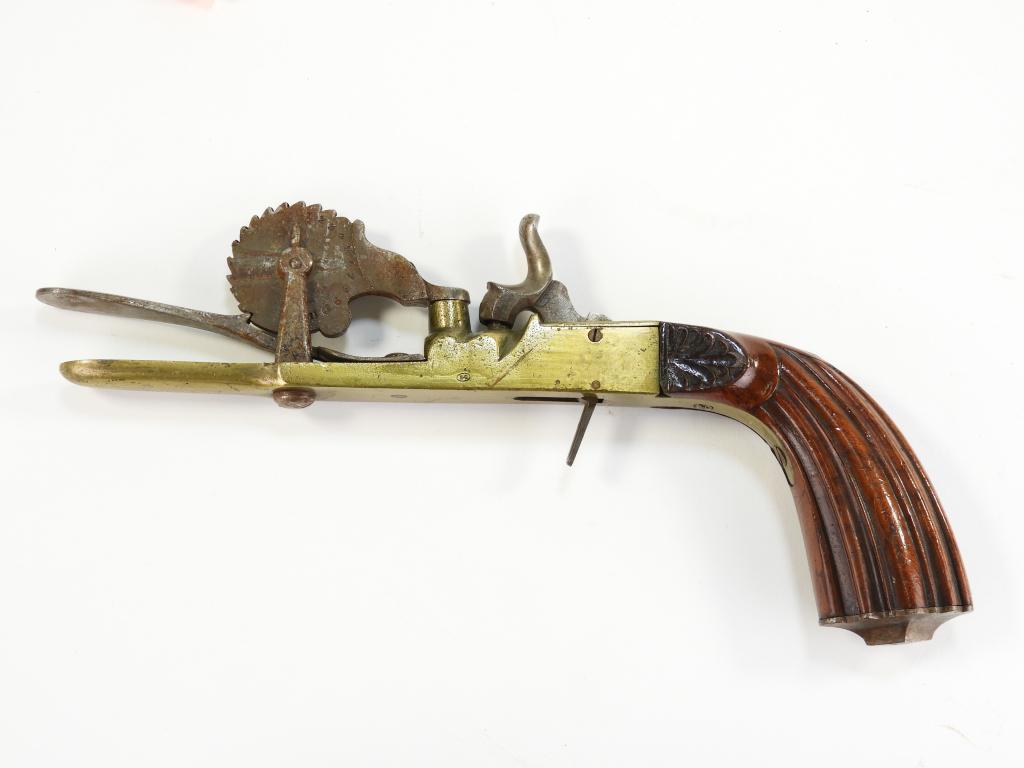 Percussion Powder Tester: France/Belgium C. mid-19th century Walnut grip with carved lines and foliate designs, brass frame with small a small "BC" marked in an oval on each side of the frame, and a steel measuring wheel with 