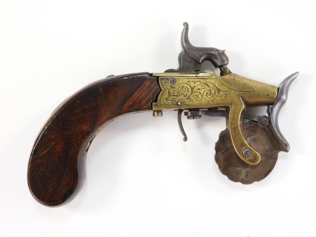 Percussion Powder Tester: England C. mid-19th century Walnut grip with a small silver escutcheon, brass frame engraved with foliate designs, marked on the frame tang "J/ROBINSON," with an iron measuring wheel. Overall lg. 6".