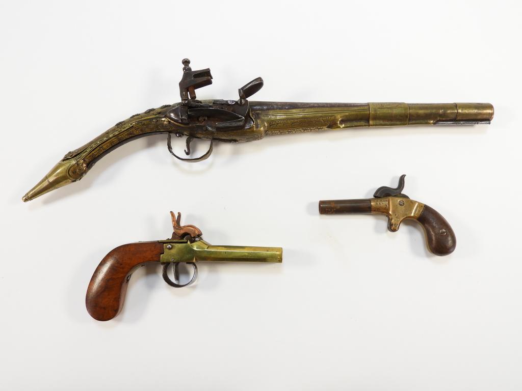 Three Pistols: C. 19th century A two barrel brass percussion pistol, an A.S.T. "HERO" single shot percussion pistol, and a Balkan rat tail miquelet lock pistol with brass frame.