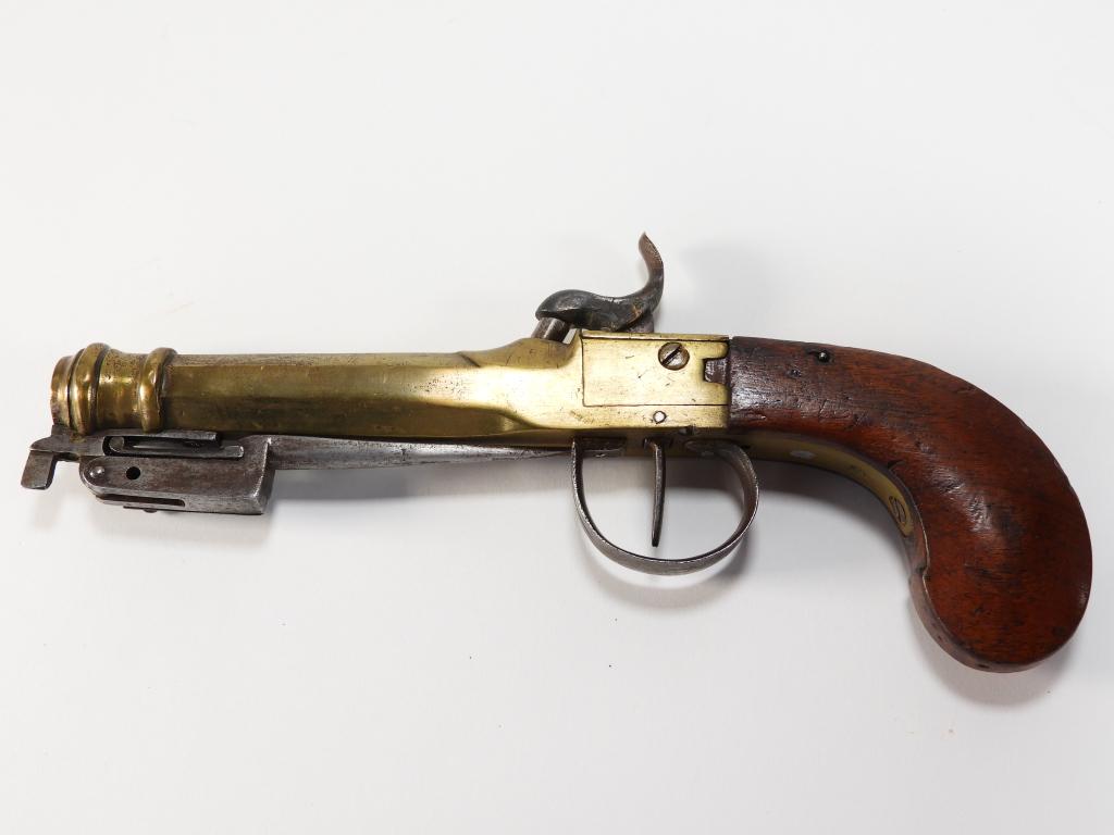 Brass Barrel Boxlock Pistol With Bayonet: Probably England C. early 19th century .51 bore, walnut grip, brass barrel and frame with a small stamp behind the trigger that looks like a crown over "GR," steel trigger guard, and a spring loaded b