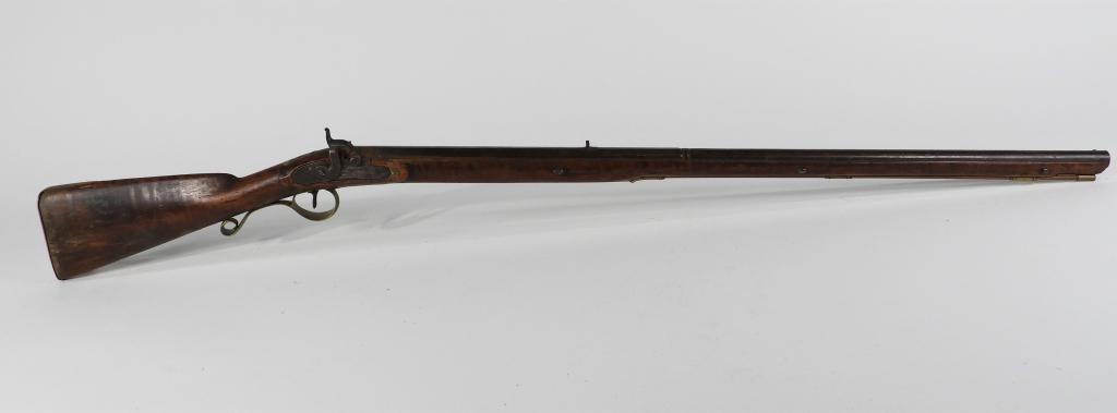 Percussion Fowling Piece: United States C. 1830s .50 bore, maple stock, brass fittings, lock engraved with foliate designs, octagonal to round barrel, with a brass tipped wooden ramrod. Barrel lg. 35 5/8".Overall lg. 49 1/2"