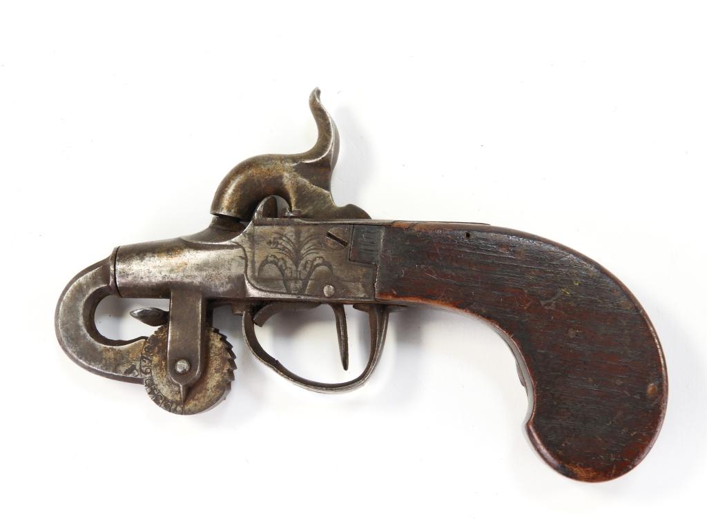 Percussion Powder Tester: England C. 1840s Walnut grip, steel frame engraved with foliate designs, and a steel measuring wheel with numbers on the left side. Overall lg. 5 5/8".