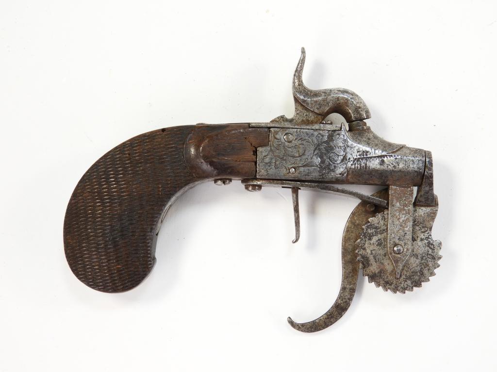 Percussion Powder Tester: England C. 1840s Walnut checkered grip, steel frame engraved with foliate designs, and a steel measuring wheel with numbers on the right side. Overall lg. 5 1/4".