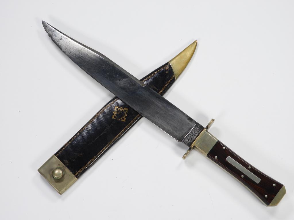 Blofeld Bowie Knife and Sheath: England C. 1830s-50s German silver hilt and guard, rosewood grips with a German silver inlay, blade marked on the ricasso "BLOFELD/6 MIDDLE ROW/HOLBORN," a leather sheath (replacement) with gilt embos