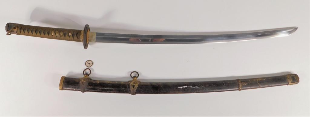 Japanese Naval Officers Kai-Gunto Katana: Japan Tan/brown ito, brass menuki, black ray skin grip, silver washed copper habaki, numbered tsuba, tang marked with painted initials and "853," shagreen-wrapped wooden scabbard with navy mounts. Bla