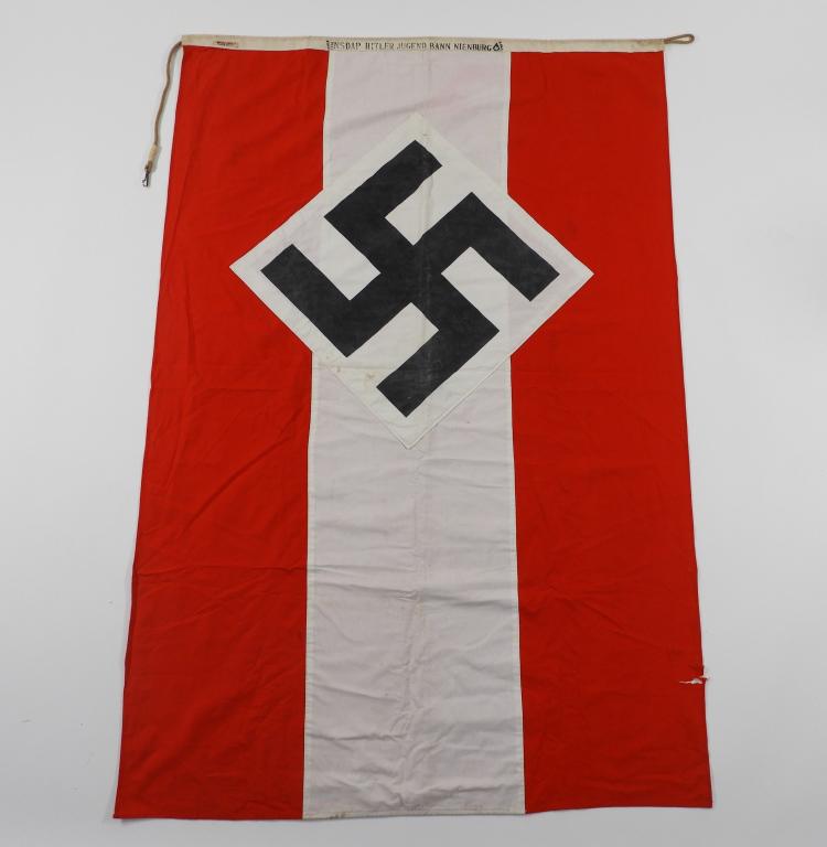 WWII German 1938 Hitler Youth Flag: Germany C. 1938 Red, white, and black cotton flag with HJ diamond in the middle, cotton hoist maker marked "JANUS & CO. K.G./RZM 825," with "426333/1938/NSDAP HITLER JUGEND BANN NIENBURG/446 HI." Ht. 