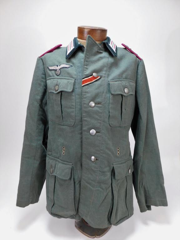 WWII German Model 36 Panzer Captain's Tunic: Germany C. 1939 Field gray broadcloth enlisted tunic adapted for an officer, dark green collar with litzen, captain's epaulets, embroidered breast eagle, an iron cross ribbon, and lined with cotton tw