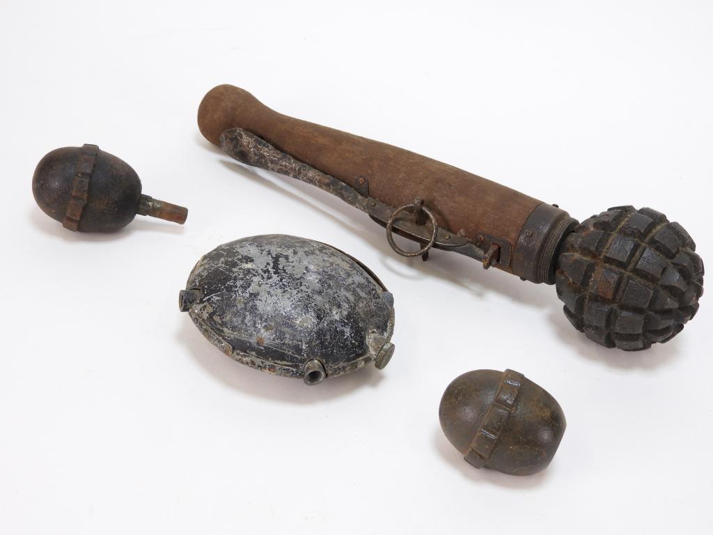 Four WWI German Inert Grenades: Germany C. 1914-18 A Model 1915 lever-style grenade, two egg grenades, and a disc grenade.