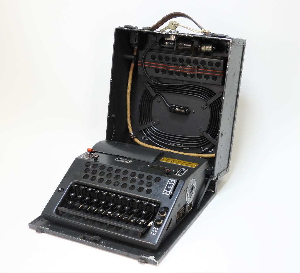 Swiss Model 45 NEMA Cipher Machine: Switzerland C. 1950 Gray-painted case with "294" stenciled in white on the top, "TD 294" stenciled on the front, with a leather handle, lock, and keys, inside data plate marked "Zellweger A.-G./Appara