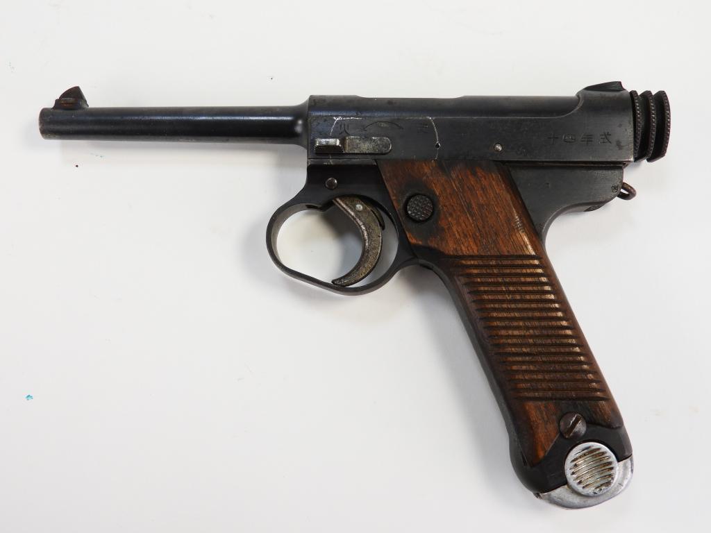 Japanese Type 14 Nambu Pistol: Japan C. 1939-45 .8mm, serial number 23469, walnut grips, blued finish, with markings on the frame and slide, and a magazine. Note: FFL/C&R Barrel lg. 5 1/2".Overall lg. 9 1/8"