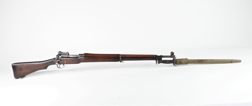 British Pattern 1914 Enfield Rifle and Bayonet: England C. 1914 .303 caliber, serial number 182735, walnut stock with a "T" inlayed on the right side, receiver ring marked "ERA," with proof marks on the left side of the receiver, with a bayonet and