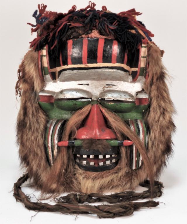 Attr. Wobe Tribe Poro Society Carved Wood Mask: Africa, 20th Century Polychromatic carved wood mask with protruding eyes, wide flat nose, open mouth with inset teeth, and fur and fiber around the edges. Approx. 18" t x 14 1/2" w x 6 3/4" d. From th