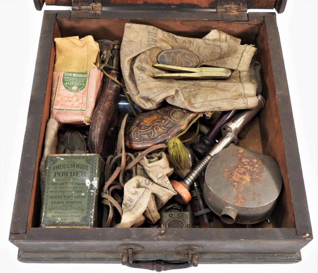 American Shotgun Box w/ Accoutrements: United States,19th Century Includes powder flasks, a shotgun flask, a American Wood Powder canister, a United States Military belt buckle, a 31cal. bullet mold, gun wadding, and other accoutrements. B