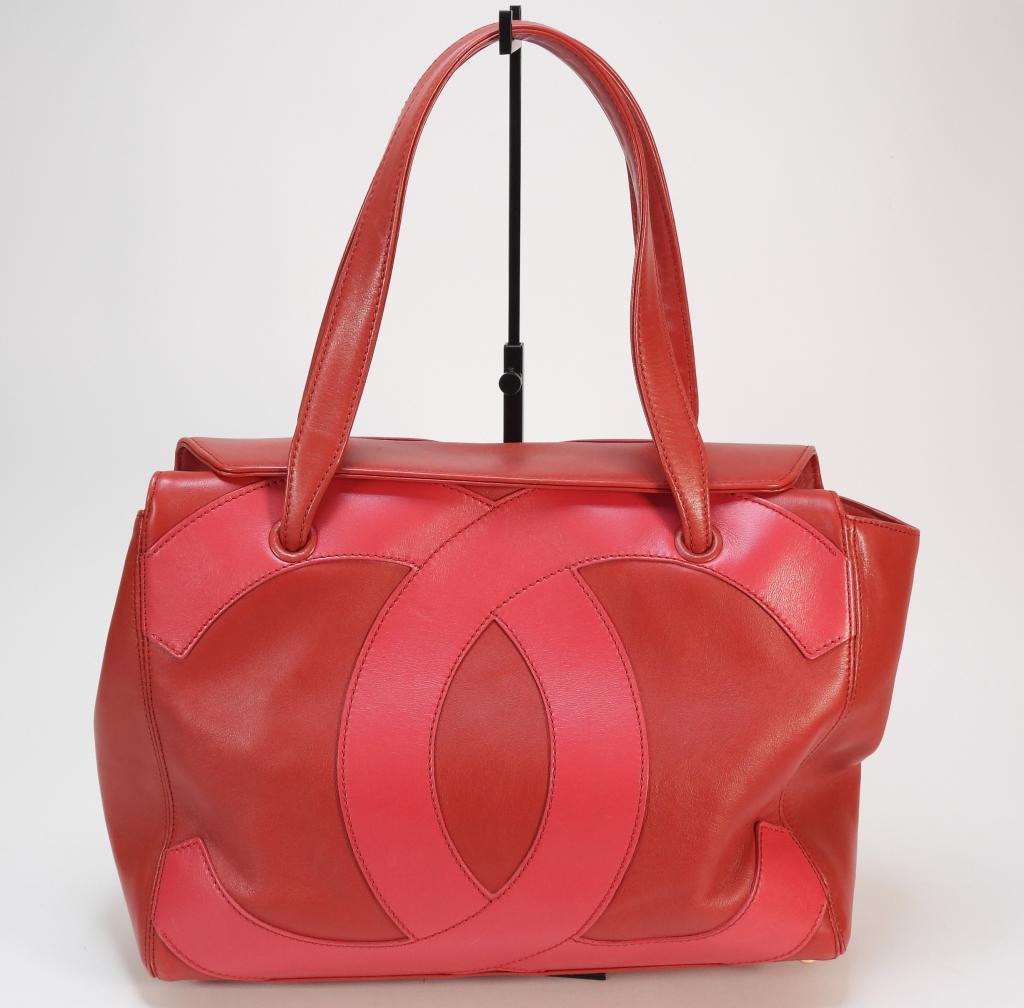 Chanel Red Leather CC Bag: Double handled bag with deep pink "CC" logo emblazoned to front sides and gold metal hardware. Guaranteed authentic with authenticity card and original dust bag. Leather,Approx. 10 1/2" t x 14" w x 4"