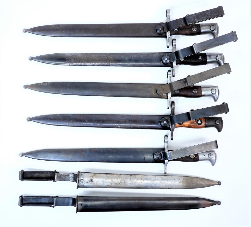 Five U.S. Krag-Jorgensen Bayonets and Scabbards: United States, A bayonet and scabbard dated 1899; a bayonet and scabbard dated 1903; a bayonet and scabbard dated 1902; a bayonet and scabbard dated 1900; a bayonet and scabbard dated 1899 (grip pins 