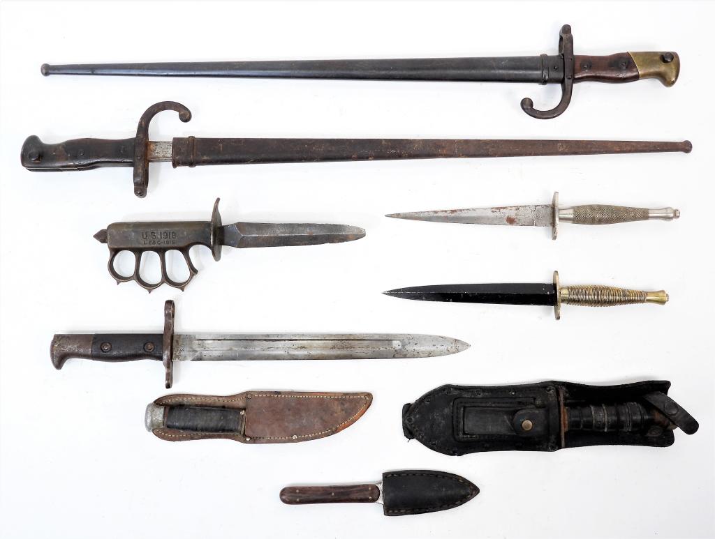 Group of Bayonets and Fighting Knives: , Two French Gras bayonets and scabbards; a Model 1918 fighting knife without a scabbard; a survival knife; a Krag bayonet missing the scabbard; two Fairbairn-Sykes fighting knives without scabbards; 