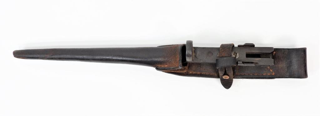 U.S. Johnson Model 1941 Bayonet and Scabbard: United States, Parkerized steel bayonet with lead in the cutout numbered "8827", with a leather scabbard. Blade lg. 7 3/4".Overall lg. 11 3/4" 17.5% Buyers Premium with a 3% cash or check discount whi