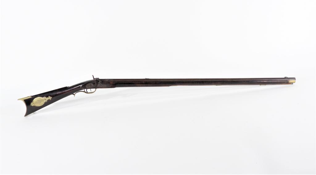 Kentucky-style Full Stock Percussion Rifle: United States,C. 1840s .50 caliber, figured maple stock, brass trigger guard, patch box, ramrod pipes, and nose cap, German silver inlay on the cheek pad, lock engraved with foliate designs and "RIDDL