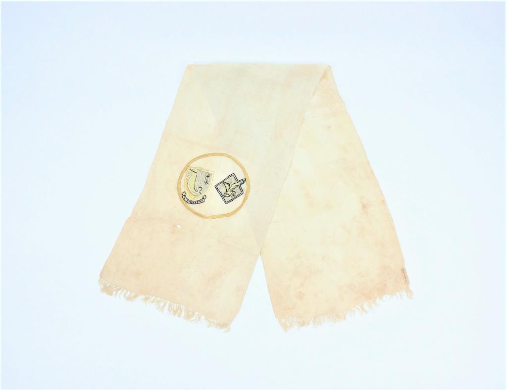 WWII U.S. 376th Bomb Group Silk Scarf: ,C. 1942-45 White silk scarf with hand felled edges, with embroidered 513th Bombardment Squadron and 376th Bomb Group insignia, cloth label with J. J. Wright Jr. embroidered on it, and fringed ends. W