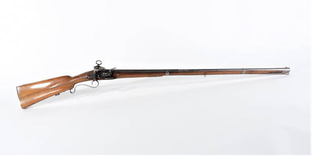 Spanish Miquelet Musket Fusil: Spain C. 1760 .69 bore at the flared muzzle, ornately carved walnut stock with foliate designs on the apron near the barrel tang and at the ramrod entry, dual lines along the barrel line and the edge