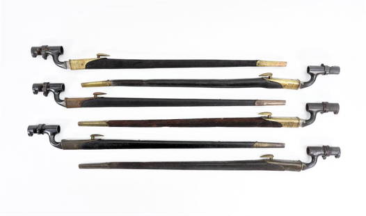 Six British Martini-Henry Bayonets and Scabbards: England Six Martini-Henry blued steel triangular socket bayonets with black leather scabbards and brass fittings. Blade lg. 21 3/4".Overall lg. 25" Blade lg. 21 3/4".Overall lg. 25"