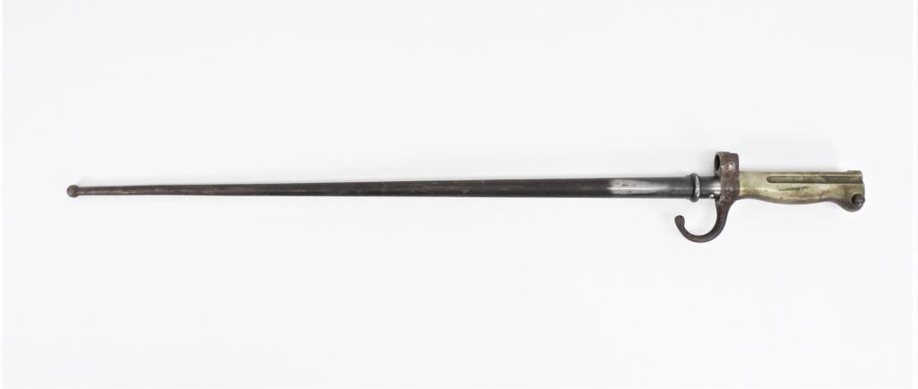 French Model 1890 Gendarmerie Bayonet and Scabbard: Alloy grip with push button release, cruciform blade, and a blued steel scabbard. Blade lg. 20 1/2".Overall lg. 25" Blade lg. 20 1/2".Overall lg. 25"