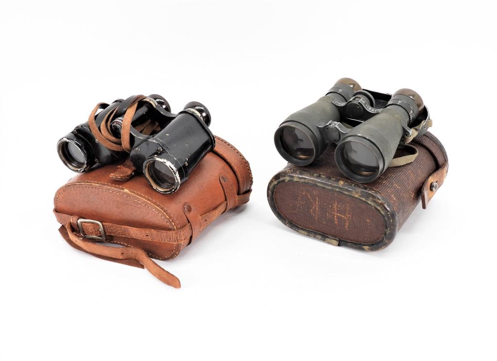 Two Pairs of German Binoculars: Germany A pair of Dienstglas 6x30 binoculars marked "ddx" and a leather case; and a pair of Fernglas 08 binoculars with the strap, eye piece cover, and ersatz case.