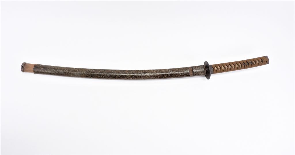 Japanese Katana and Scabbard: Japan Brown tape-wrapped shagreen grip with a mekugi on each side, iron tsuba, steel blade, and a shagreen covered wood scabbard with iron fittings. Blade lg. 24 3/4".Overall lg. 34 3/4" Blade lg. 24 