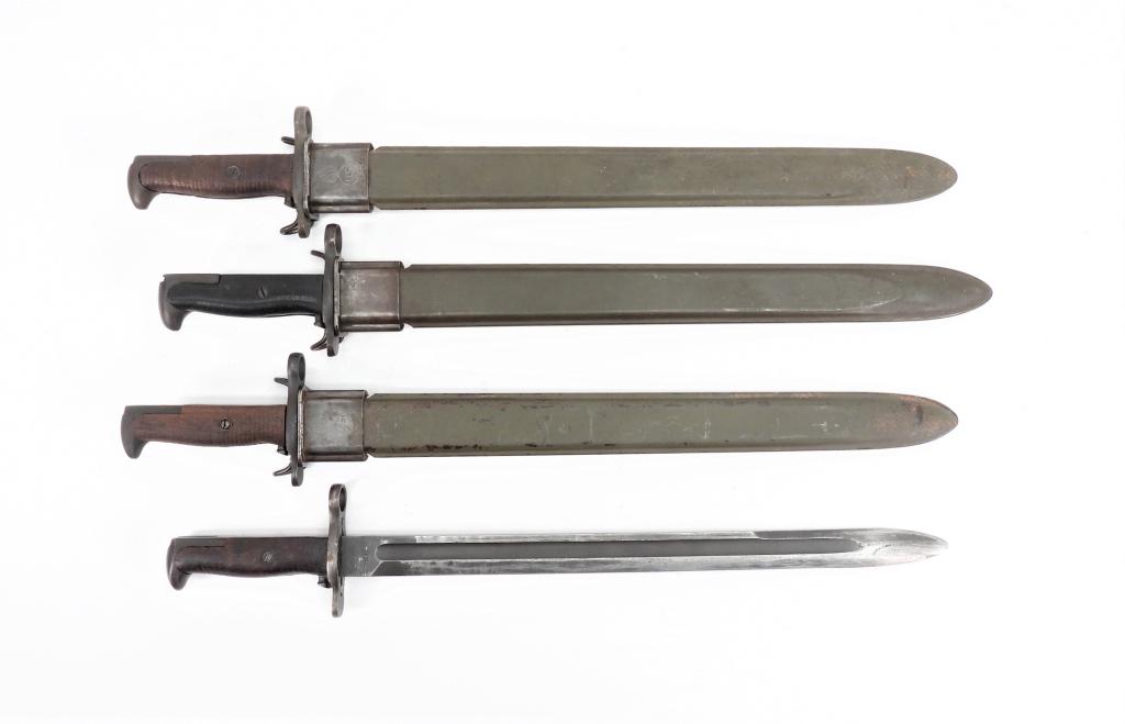 Four U.S. Model 1905 Bayonets: United States A bayonet with no scabbard, marked "SA/1918"; a bayonet marked "RIA/1917" with a fiberglass scabbard; a bayonet marked "U.F.H./U.S./1943" with a fiberglass scabbard; and a bayonet marked