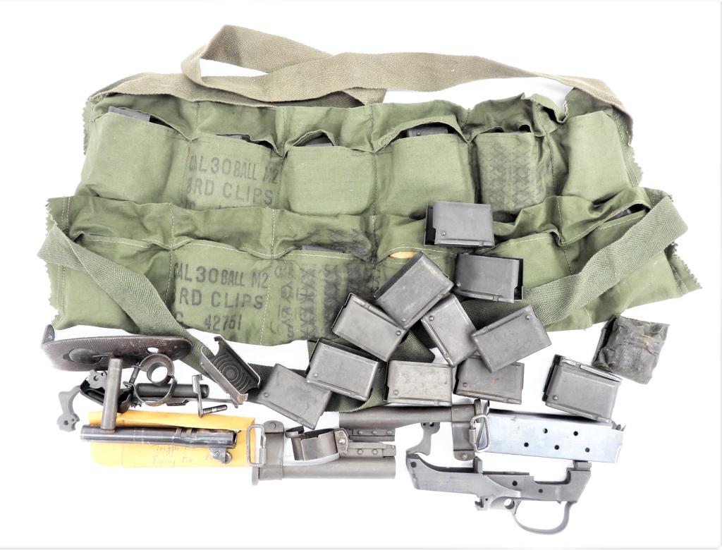 Group of Military Gun Parts: A stripped Rock-Ola M1 Carbine trigger group housing; two M1 Carbine type III front barrel bands with bayonet lugs; a type II barrel band; two M1 Carbine oilers; an M1 Carbine firing pin; a magazine f