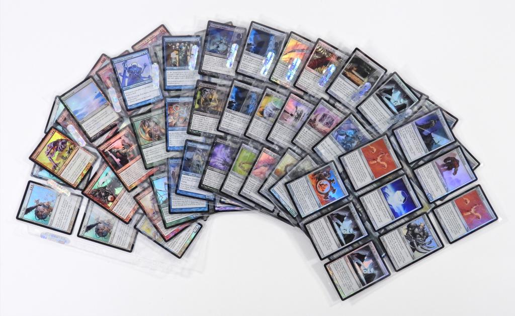 105PC Magic The Gathering Mirrodin Foil Key Cards: United States,2003 Group includes 105 key 2003 Magic: The Gathering Mirrodin foil trading cards including Mass Hysteria, Glimmervoid, Vedalken Archmage, and Confusion in the Ranks (x2) amongst others,