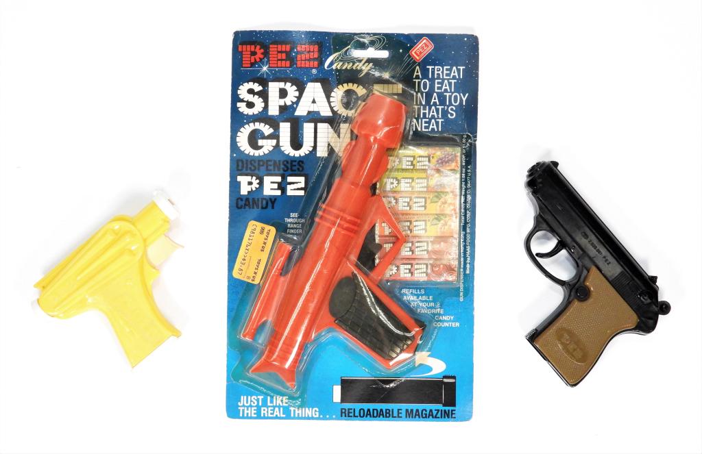 3PC 1956-82 PEZ Candy Space Gun Shooter Group: Austria,1956-1982 Group includes 1956 model Space Gun in yellow with "MADE IN AUSTRIA" mark complete with magazine, 1965 model Candy Shooter with 2.62 patent number and "U.S." mark complete with magaz