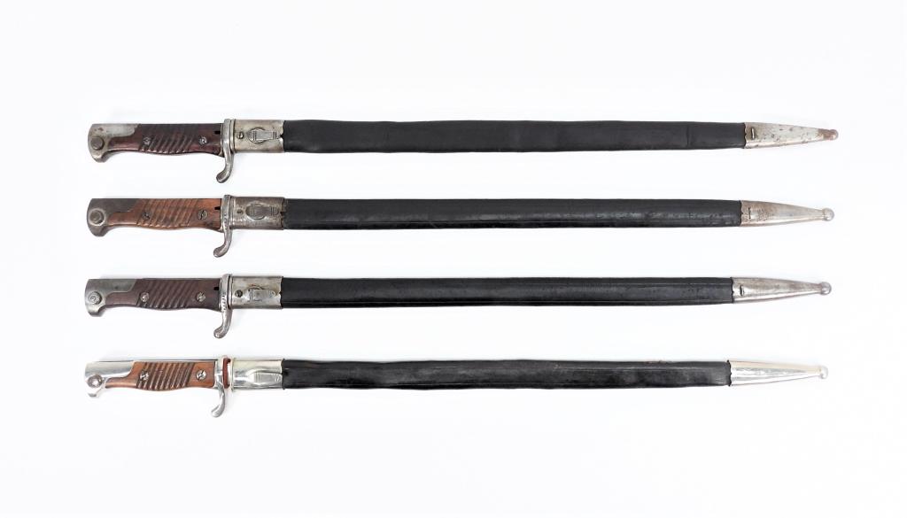 Four German Model 1898 Sword-bayonets: Germany A pipe back dress bayonet and scabbard; an 1898 n/A bayonet and scabbard with unit markings; and two 1898 n/A bayonets and scabbards. Size Blade lg. 20 5/8".Overall lg. 25 7/8" Condition All h