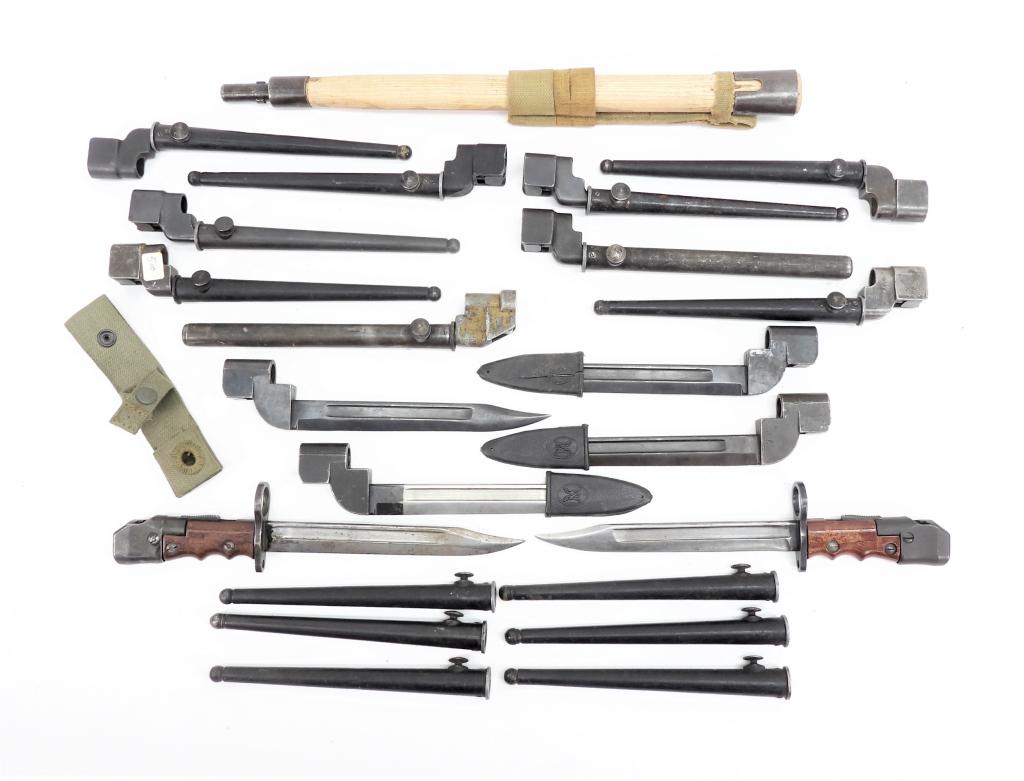 Group of British Bayonets: A wooden shaft from an entrenching tool and frog; nine No. 4 spike bayonets and scabbards; six No. 4 scabbards; two No.7 bayonets without scabbards; and four No. 9 bayonets without scabbards. Conditio