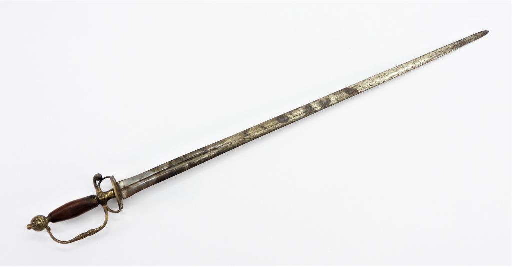 Continental Brass Hilted Small Sword: Europe C. 1720 Cast brass hilt with foliate designs on the pommel, knuckle bow, and counterguard, with a semi-flat narrow-fullered steel blade. Blade lg. 26 1/2".Overall lg. 32 3/8"