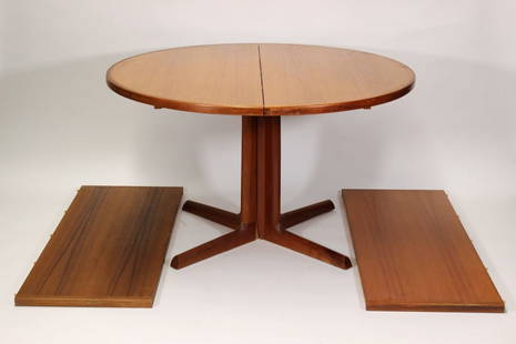 Gudme Mobelfabrik Danish Teak Dining Room Table: Denmark,mid 20th century Round teak veneer center split table supported by a pair of extendable legs with two leaves. 48" dia. x 29t 2- 19" leaves.,wood From Massachusetts estate.