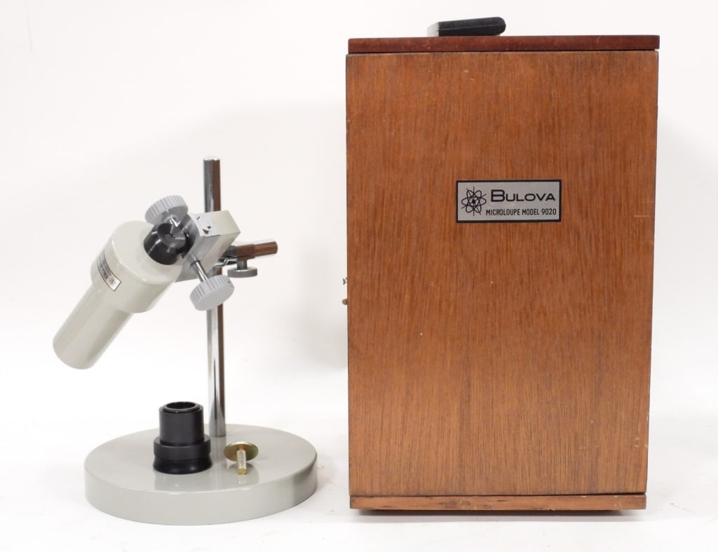 Bulova Microloupe Model 9020 w/ Case: United States,20th Century Includes a Bulova Microloupe Model 9020 for use in watch repairs with original wood travel case. Wood, metal Marked "Bulova Microloupe Model 9020" to front of case. For the