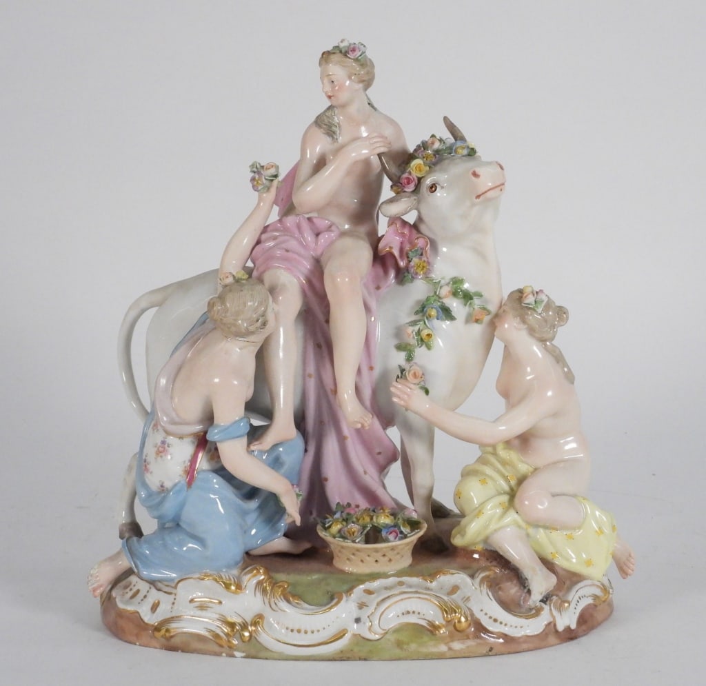 Meissen Europa & The Bull Porcelain Sculpture 9": Germany,19th Century Depicts a semi nude Europa on the back of a white bull while bare breasted women adorn her and the bull with colorful flowers. Porcelain Marked on bottom From the collection of a 