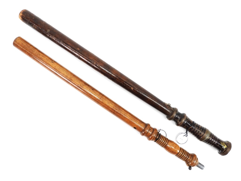 2PC Wood & Brass Nightsticks: United States,20th Century Includes an oak nightstick with tear gas dispenser in handle, and a wood and brass nightstick with flashlight. Smallest 22 1/8".Largest 24 1/4" From the collection of Matthe