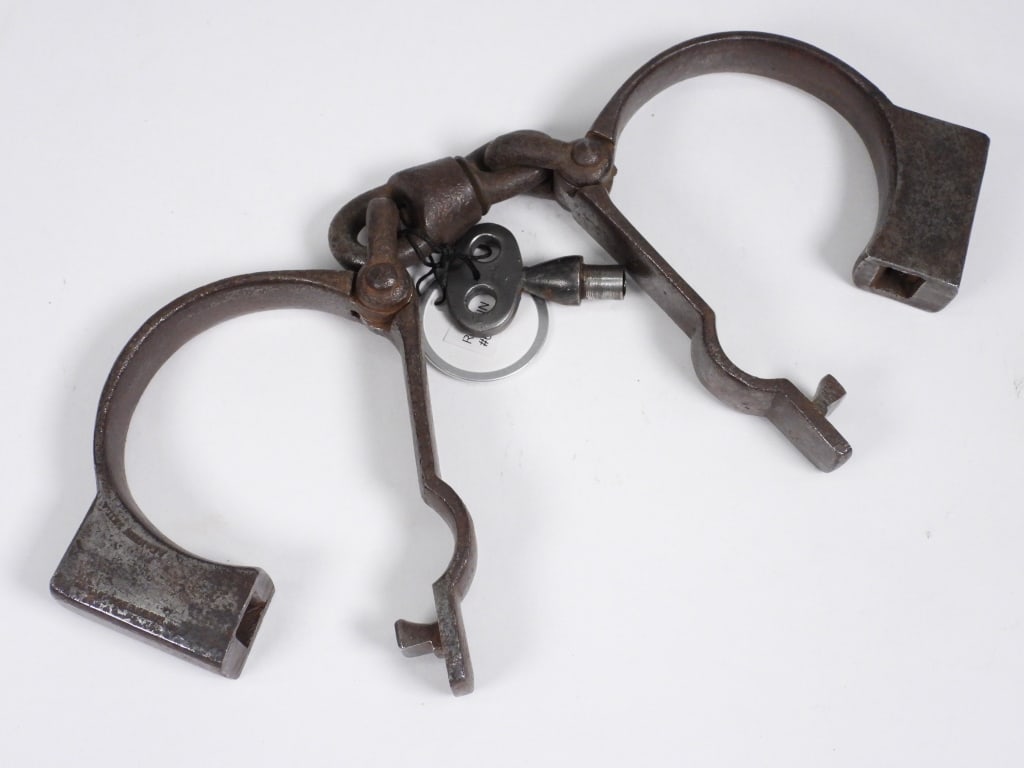 Rankin Steel Swivel Handcuffs: United States,19th Century Rankin steel handcuffs with one swivel link. Illustrated on page 85, American Police Equipment, A Guide to Early Restraints, Clubs & Lanterns, by Matthew G. Forte. 2 1/2" x