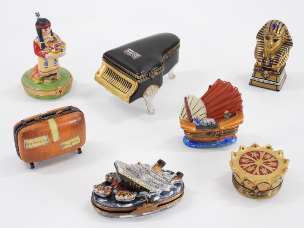 7PC French Limoges Figural Pill Boxes: France Late 19th-Early 20th Century Includes an Asian sailing boat, a pharaoh head, a Native American woman, the Titanic, a suitcase, a piano, and a crown porcelain pill box. Porcelain,Smallest 1" x 2