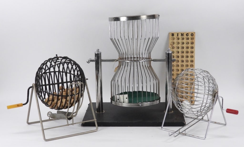 4PC Bingo & ChucK-a-Luck Dice Game Cages: United States 20th Century Includes a small bingo cage with red handle, a bingo cage with black finish and wood bingo balls, a wood bingo board, and a large Chuck-A-Luck cage with three dice. Metal, w