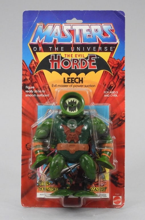 1984 Mattel Masters of the Universe Leech MOSC: United States,1984 1984 Mattel Masters of the Universe Leech action figure, C7 factory sealed with moderate wear as expected from age and storage, corner and edge wear with curled corners and areas of