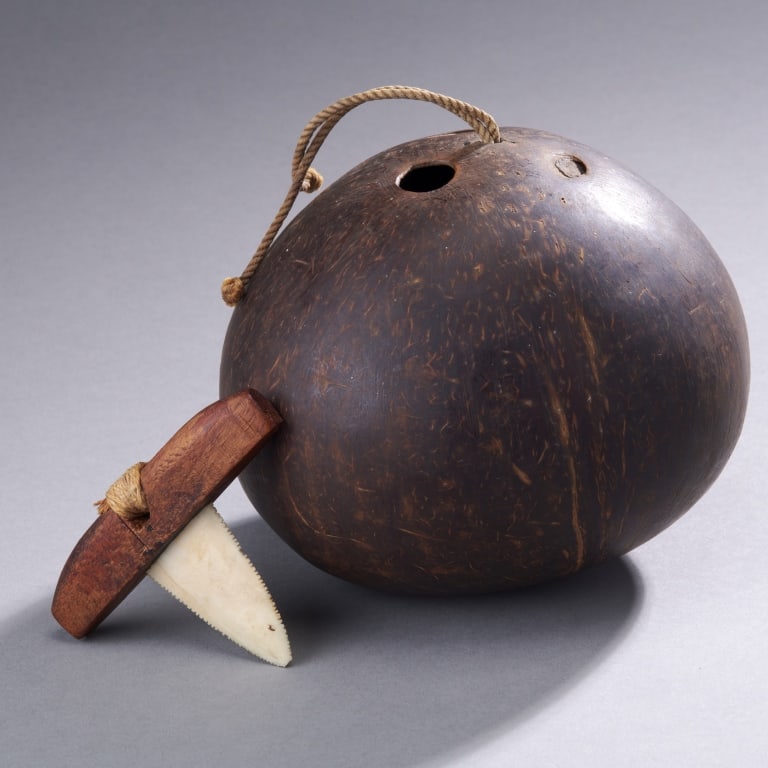 2 Oceanic Objects: Oceania,Ca. 19th - 20th century The first, a small marine bone and wood cutting tool, the second is a Fiji coconut water vessel with possibly anthropomorphic features. Vessel H. 4.75".Vessel H.12 cm
