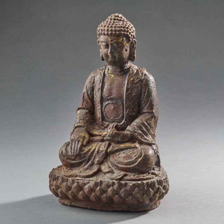 Chinese Gilt Iron Figure Of Buddha: China,Ca. 17th - 18th century The seated figure with remnants of lacquer and gilding, on a lotus base. H. 9".H. 23 cm