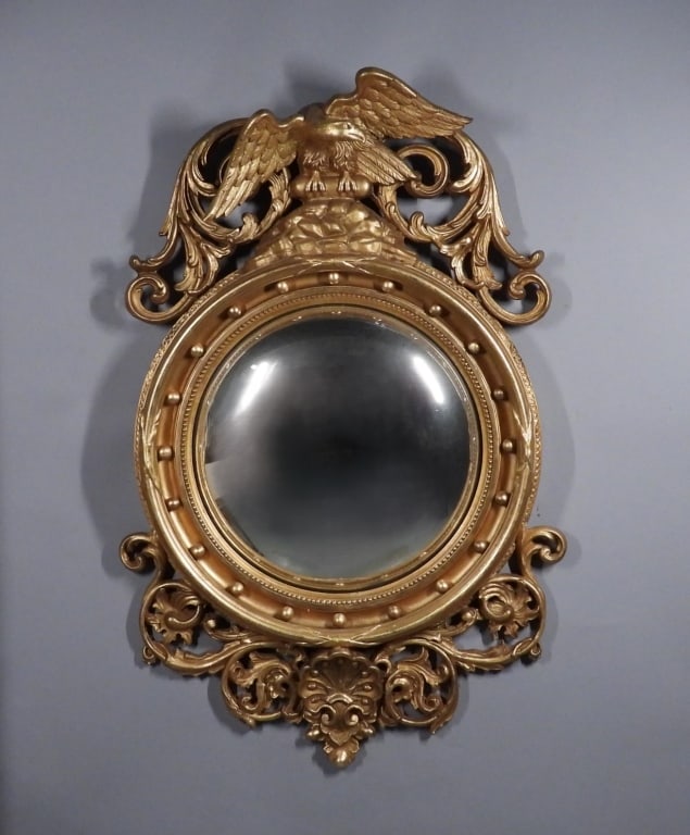 C1810 American Federal Style Bullseye Mirror: United States,Circa 1810 Carved wood gilt spread eagle and acanthus leaf pediment, reeded surround with spherules, terminating in a shell and acanthus leaf bundle. This style was developed during Amer